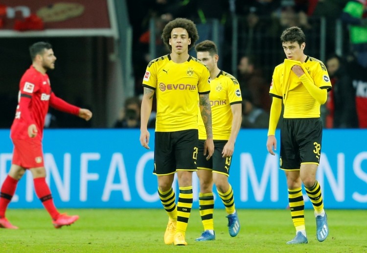 Borussia Dortmund players look upset after failing to beat Bayer Leverkusen in Bundesliga
